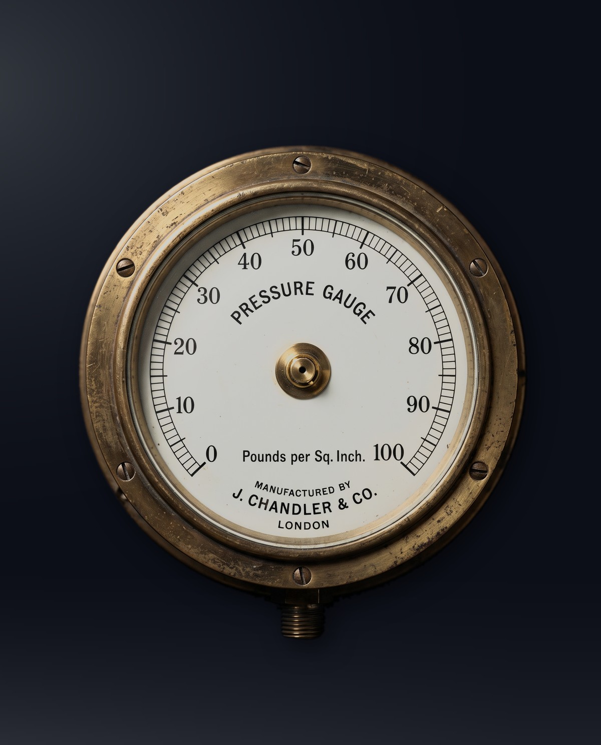 Antique brass pressure gauge, its needle climbing under load